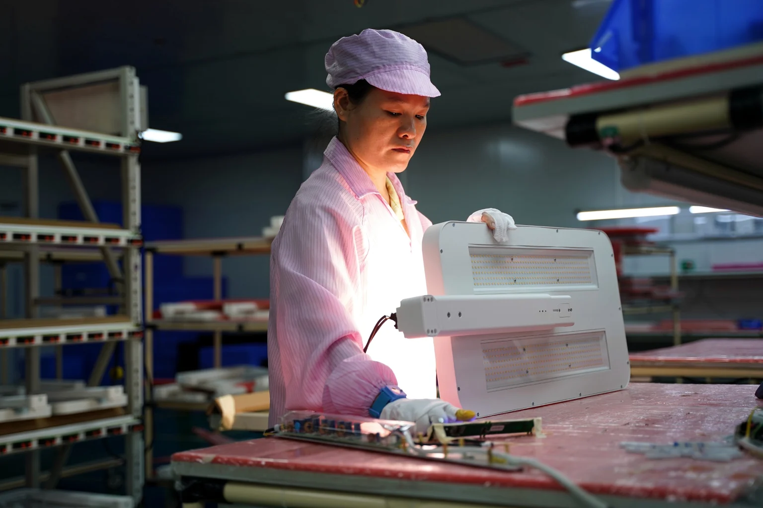 Technician completing a functional check on an office luminaire